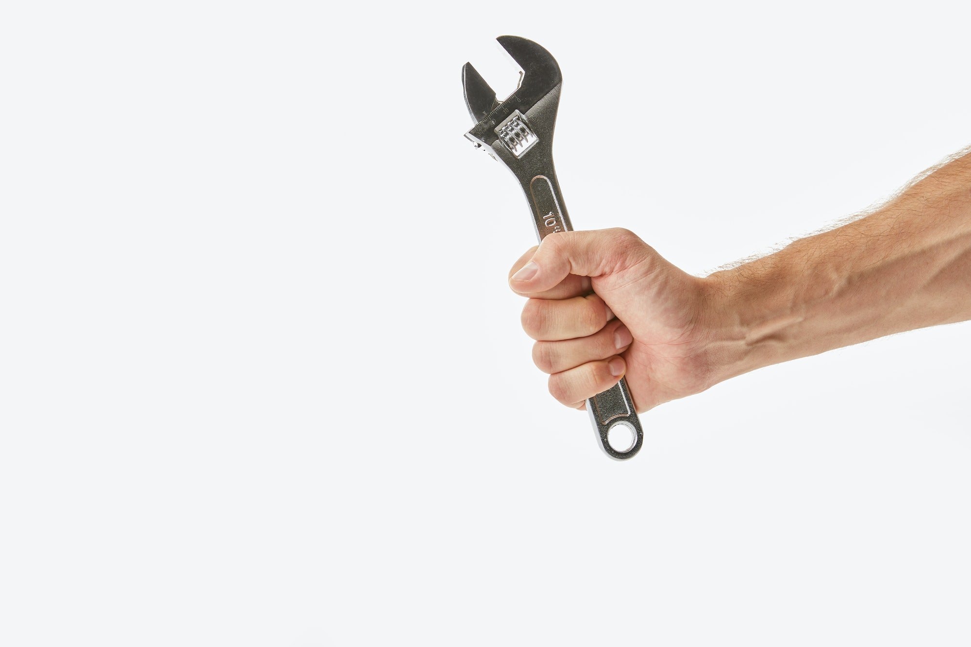 Partial view of man holding monkey wrench isolated on white